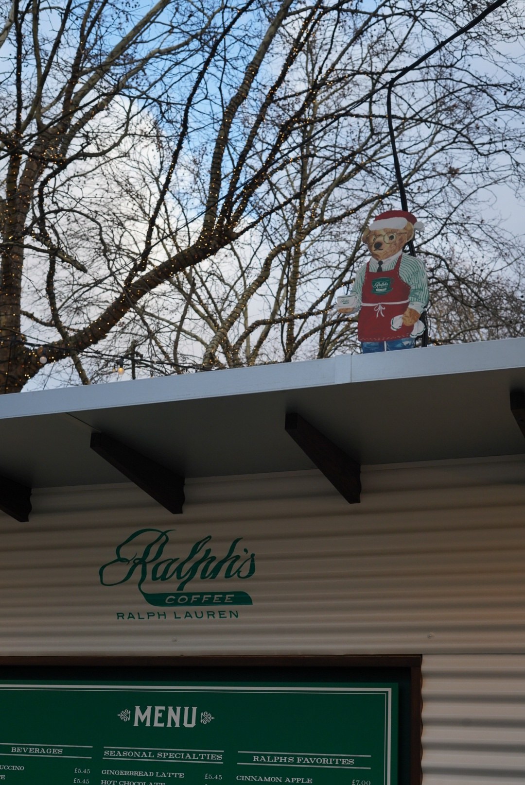The bear in a Santa hat at the kiosk roofline, London