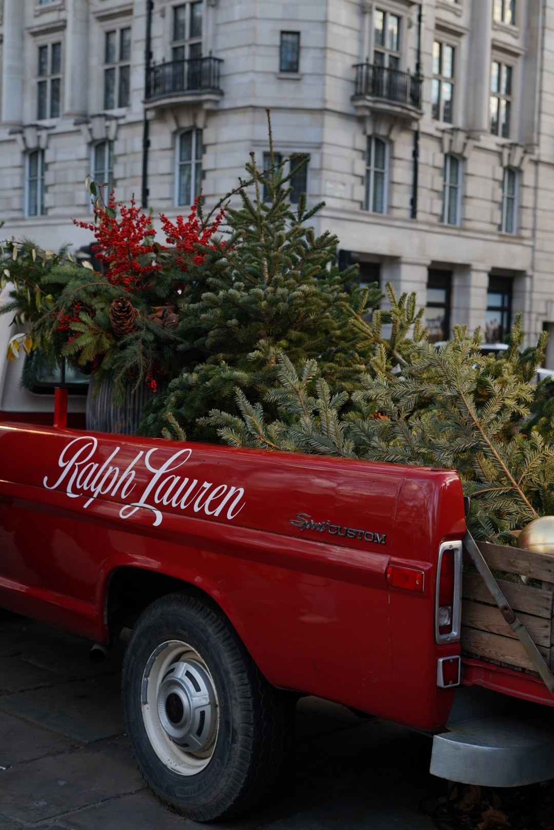 The red truck, loaded with pine and a gold bauble, Ralph Lauren script along the side, London