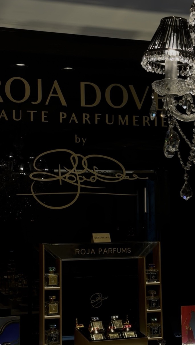 Roja Dove Haute Parfumerie signage in gold on dark lacquer with a crystal chandelier, Salon de Parfums, Harrods, London