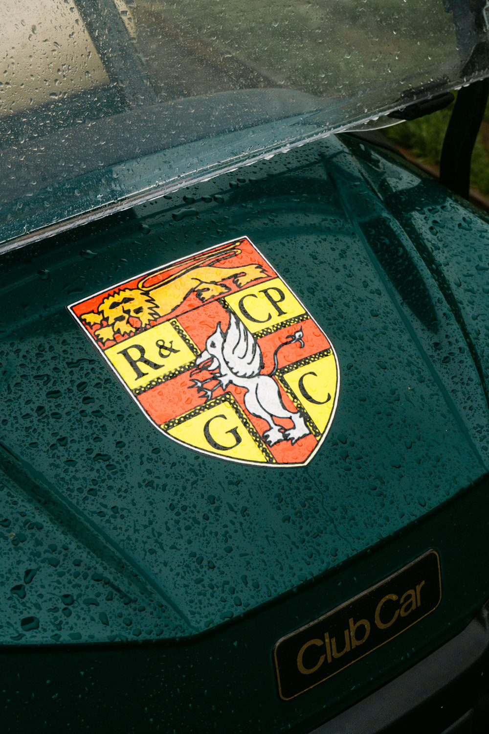 The club crest beaded with rain on the bonnet of a buggy, Rochester & Cobham Park, Kent