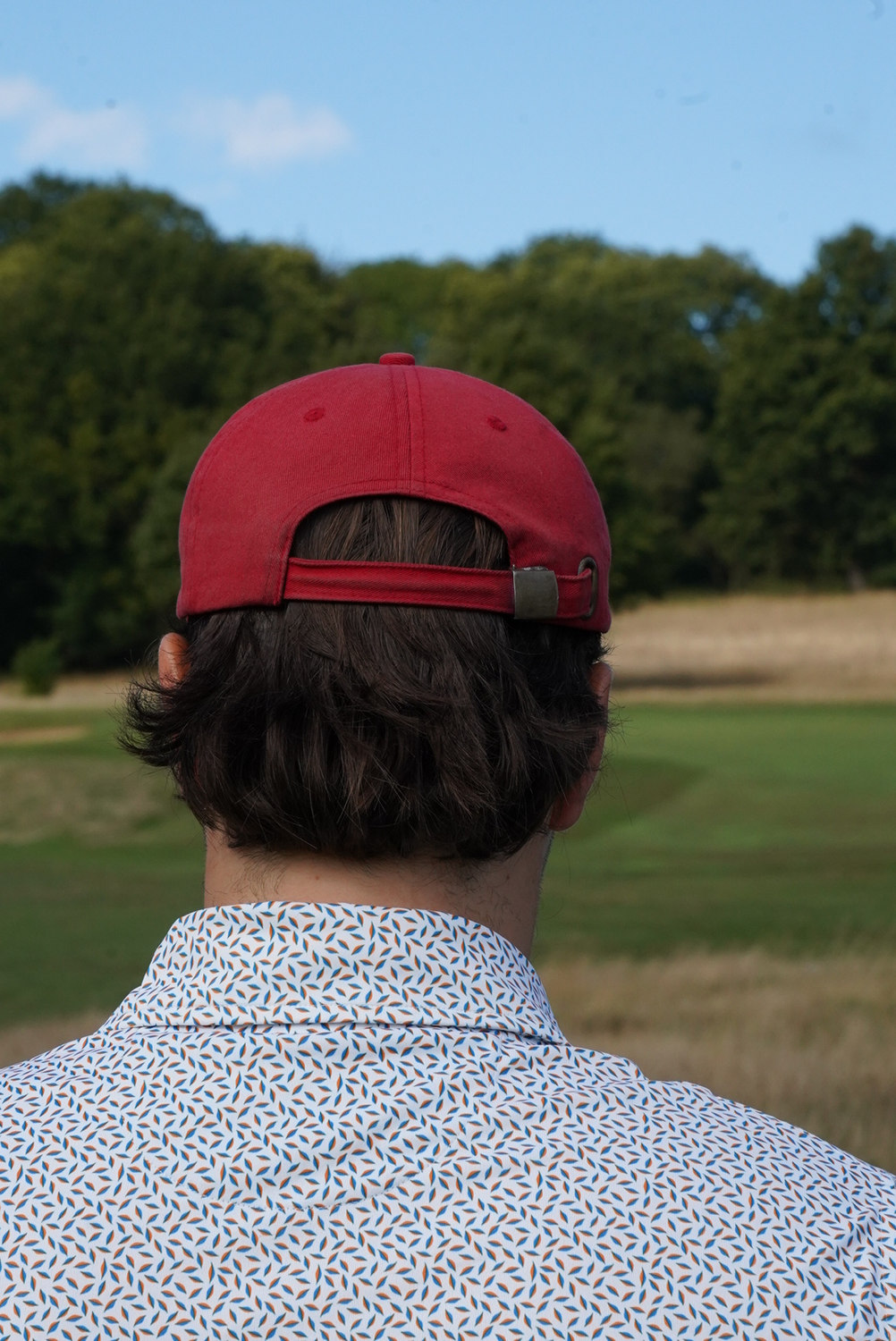 The back of a cap and a patterned shirt at the edge of the fairway, McLaren Construction Group Golf Day, Kent