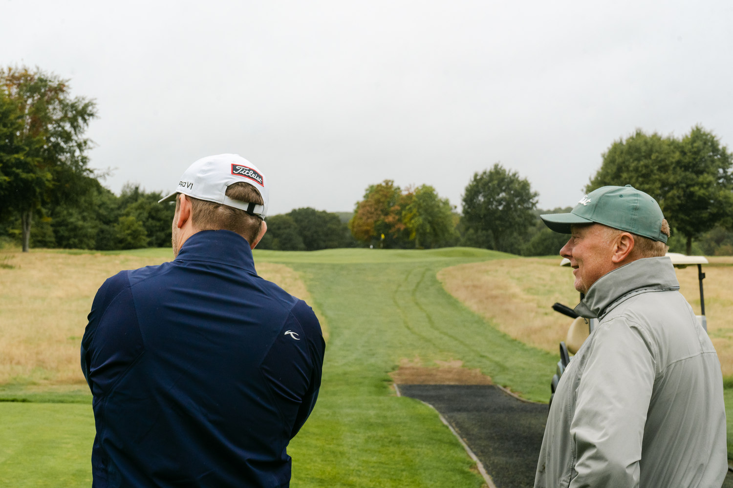 Two players watching from opposite sides of the path, McLaren Construction Group Golf Day, Kent