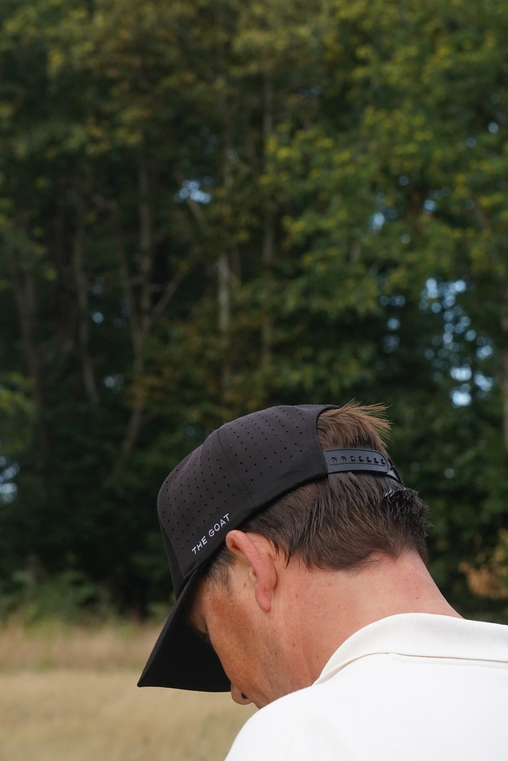 A player seen from behind under his cap, McLaren Construction Group Golf Day, Kent
