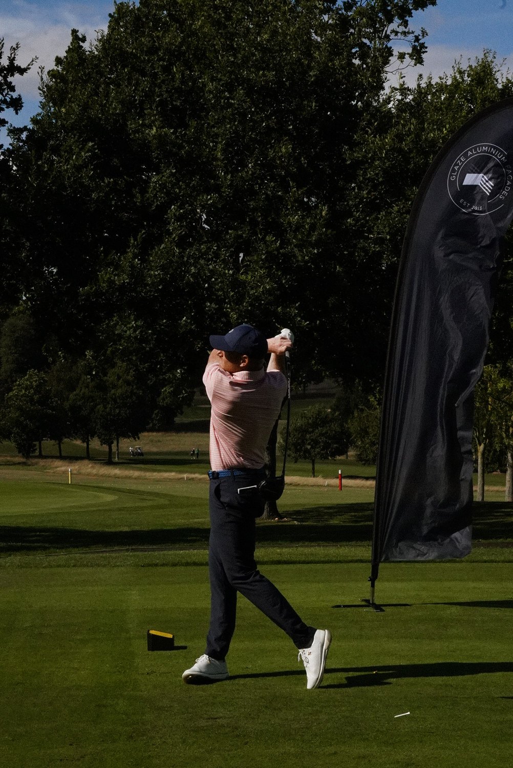 A swing played beside a partner banner, McLaren Construction Group Golf Day, Kent