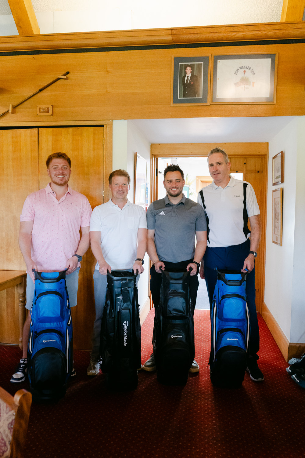 Players with their bags in the clubhouse corridor, Rochester & Cobham Park, Kent