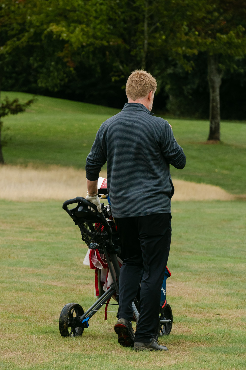 A player walking away at the end of the round, McLaren Construction Group Golf Day, Kent