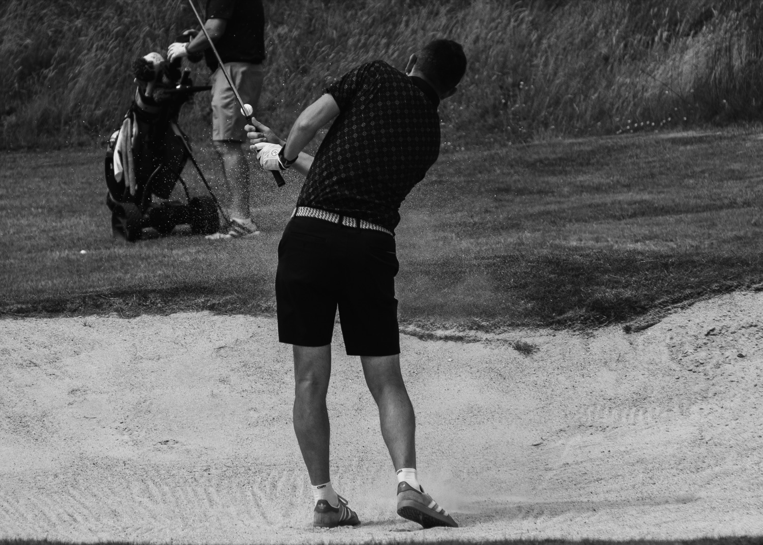 A bunker shot lifting sand, watched from the edge of the fairway, Magnolia Classic, Horsforth Golf Club, Leeds