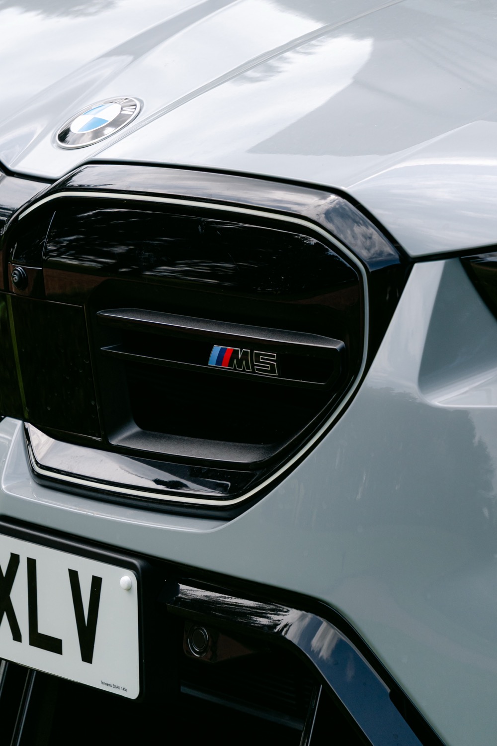 The grille of a BMW M5 parked beside the course, Magnolia Classic, Horsforth Golf Club