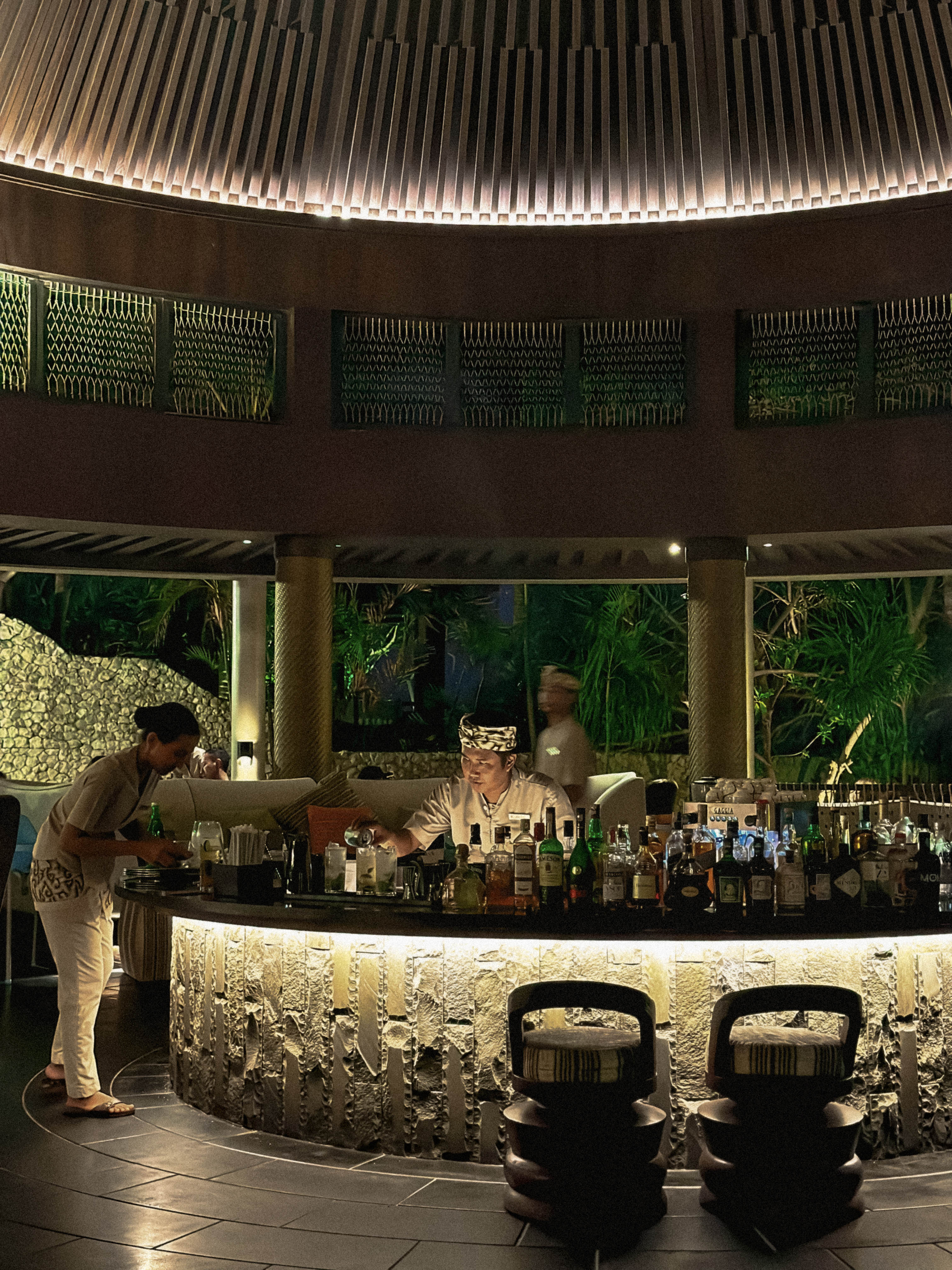 Circular evening bar, barman in Balinese headwear, The Ritz-Carlton Bali