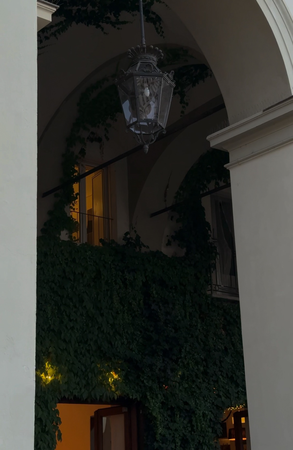 Courtyard arch with lantern and ivy, Turin