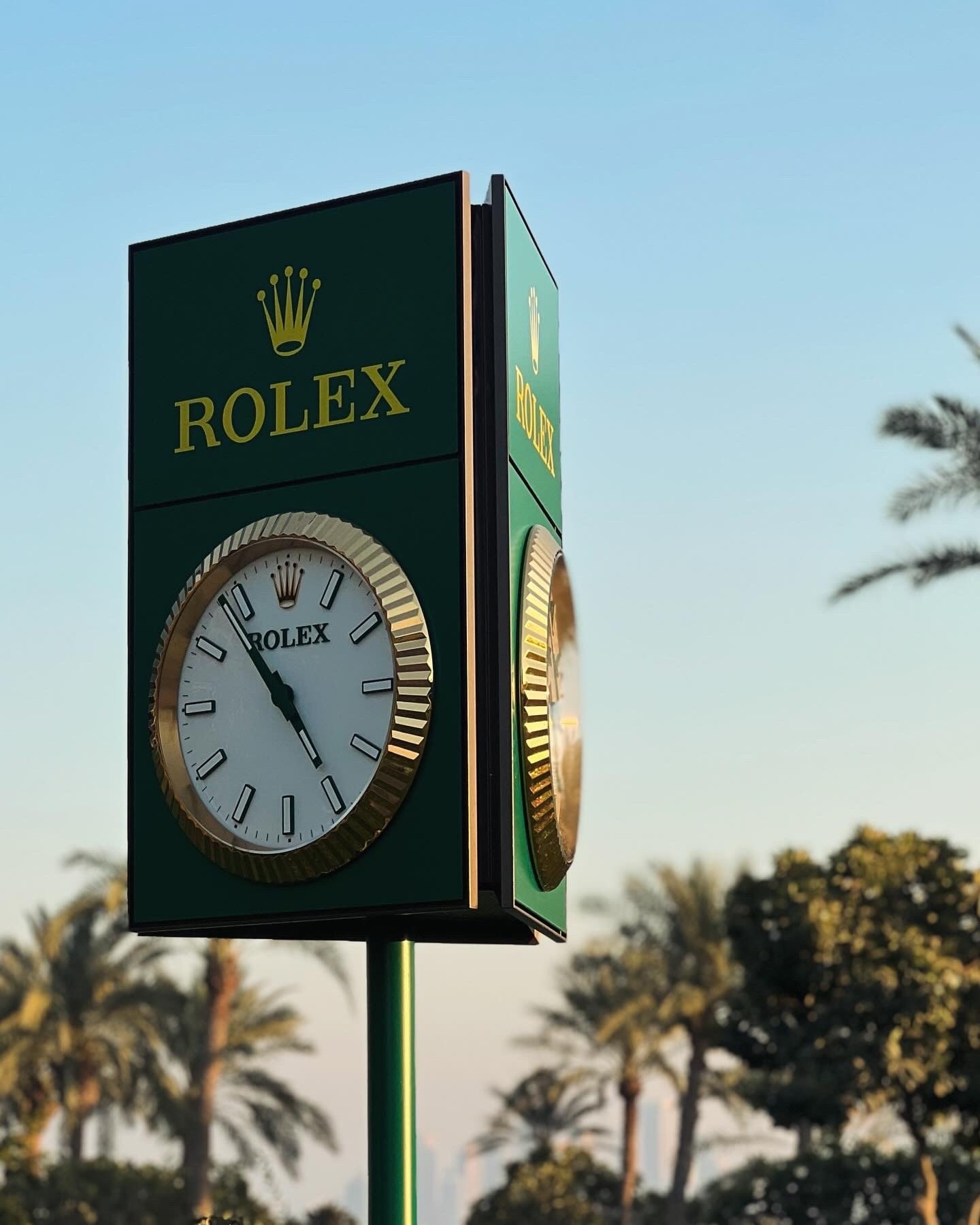 A clock among the palm trees, Doha Golf Club, Qatar