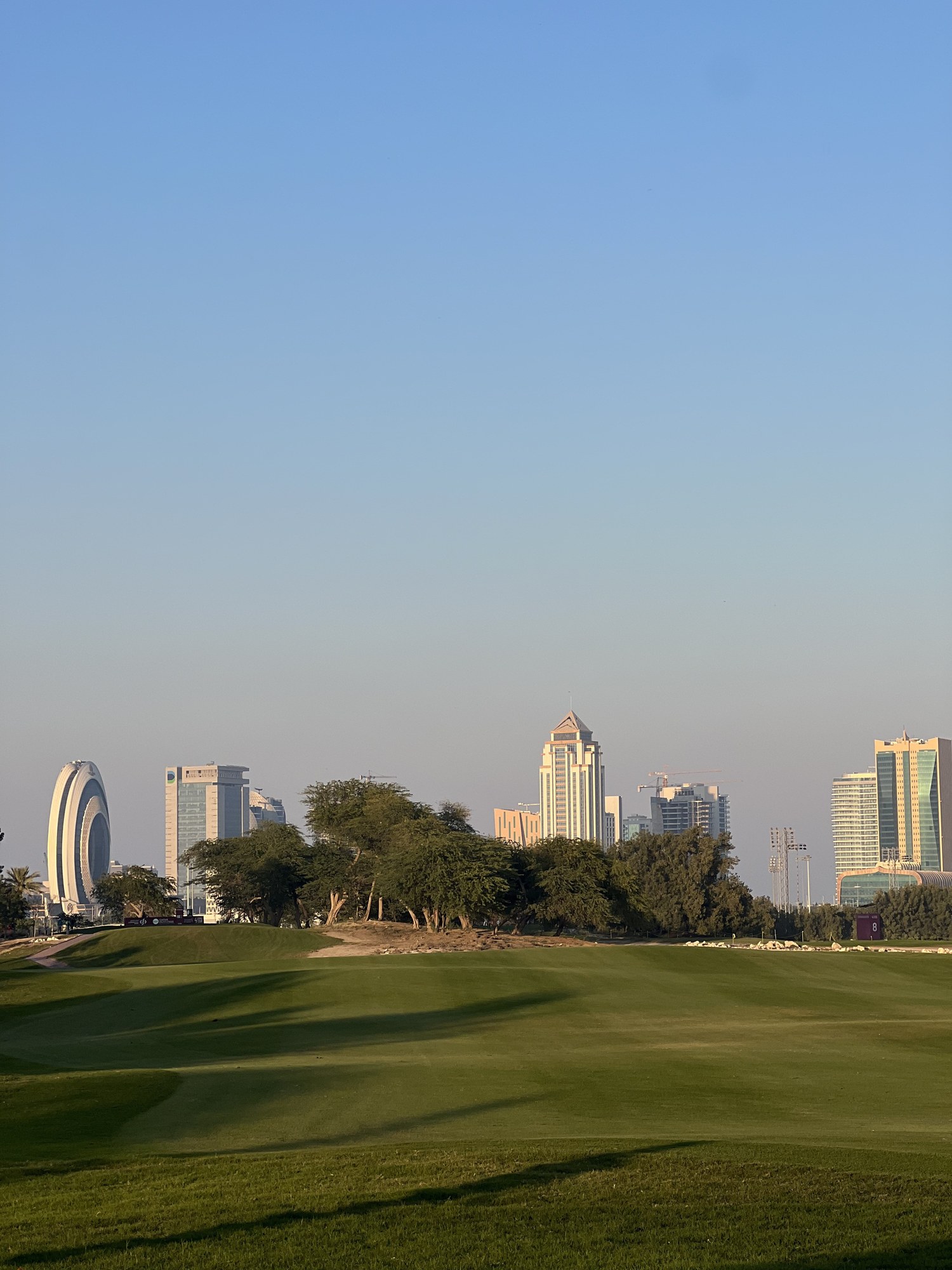 The Doha skyline beyond the course, Qatar